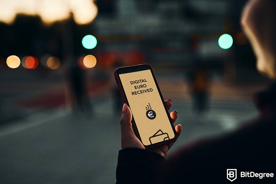 O que é Fiat em criptomoeda: uma pessoa segura um telefone nas mãos. A inscrição aparece na tela: os euros digitais são obtidos.